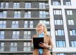 A property manager assesses the outside of a building for why-your-apartment-complex-needs-an-answering-service blog.